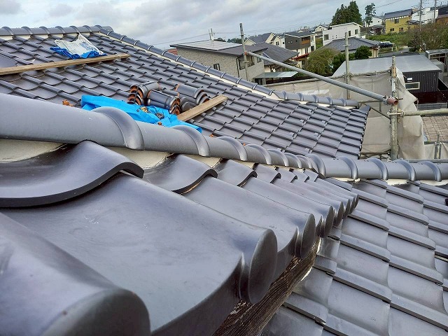 牛久市にて強風から屋根を守る風切丸の設置工程、仕込んでいた銅線で丸瓦を固定