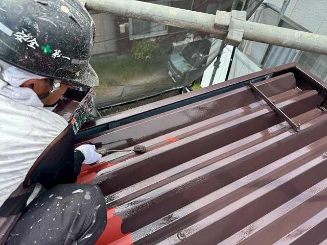 アパート建物折板屋根塗装工事のローラーによる中塗りの様子